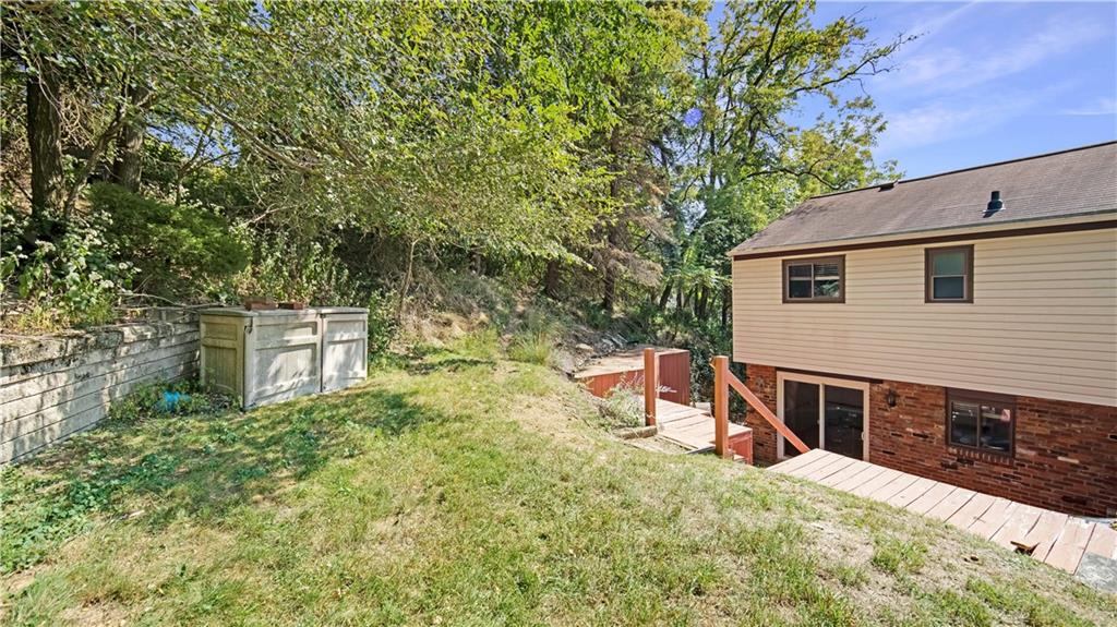 363 Dailey Road Pittsburgh, PA 15227 - Photo 22 of 23 Steps from back patio lead to green space, great for pets or kids to enjoy!