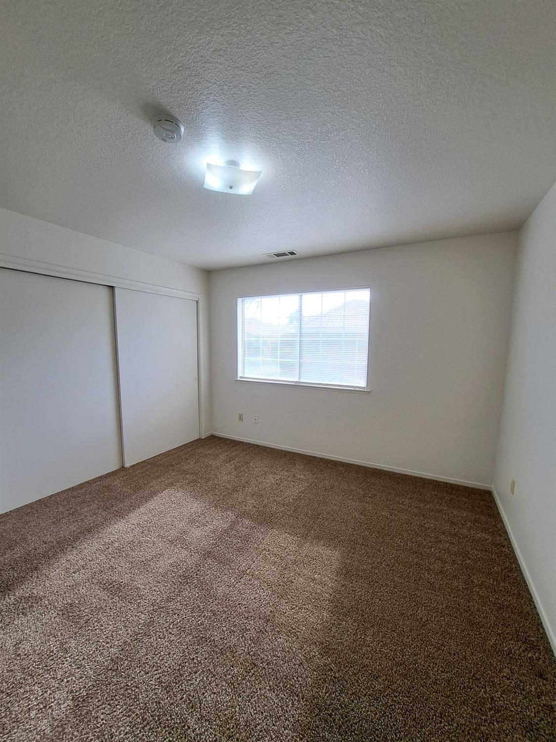 12486 Georgia Lane Madera, CA 93637 - Photo 12 of 17 an empty room with a window