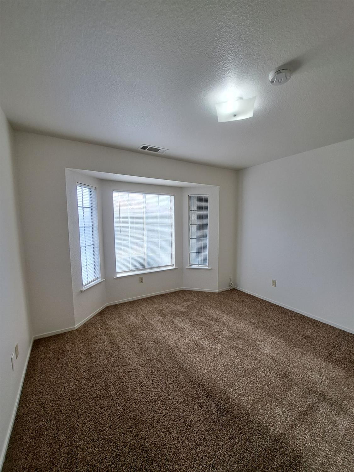 12486 Georgia Lane Madera, CA 93637 - Photo 14 of 17 an empty room with windows