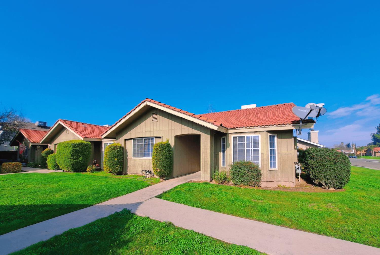 12486 Georgia Lane Madera, CA 93637 - Photo 2 of 17 a front view of a house with a yard