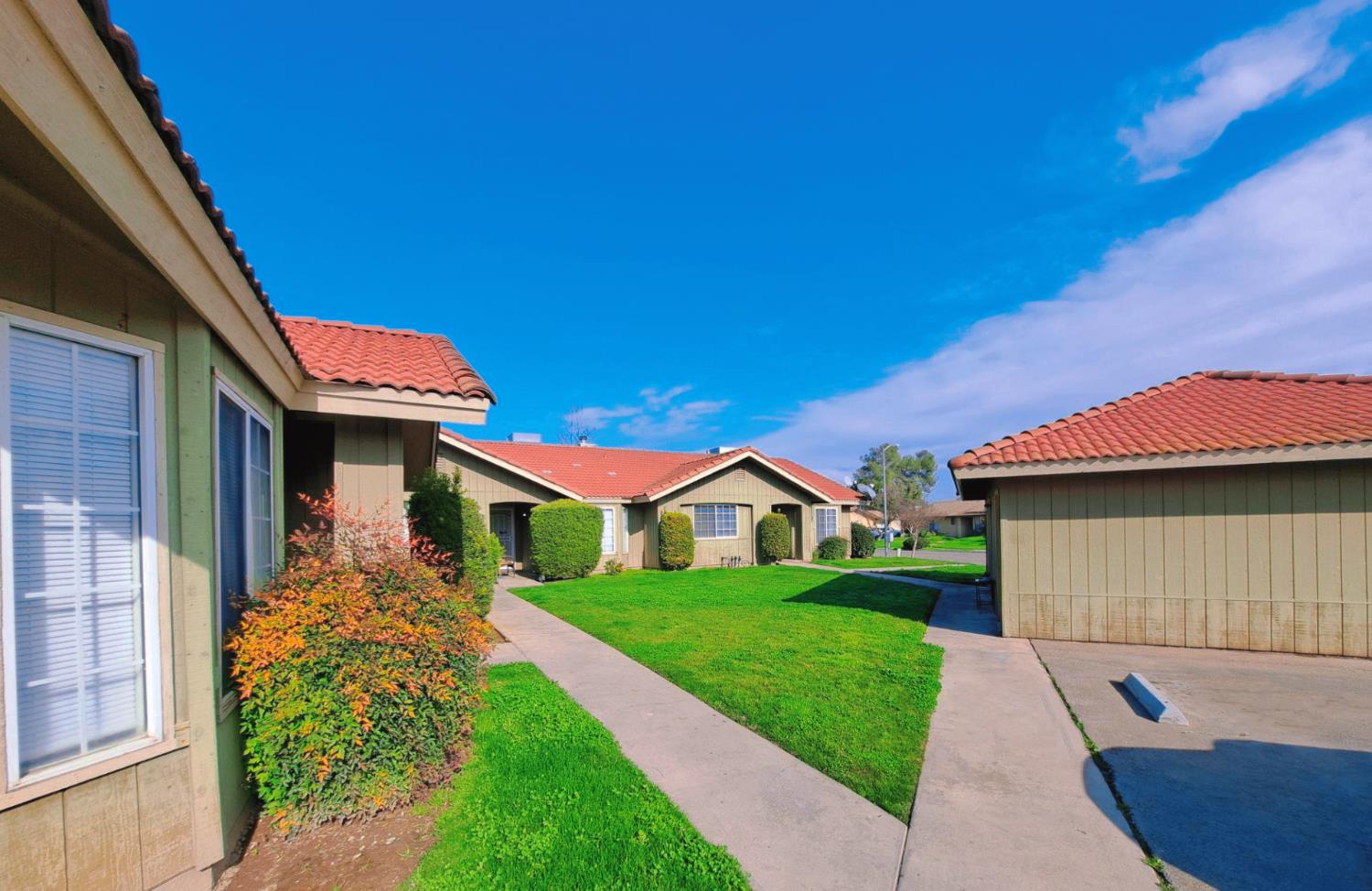 12486 Georgia Lane Madera, CA 93637 - Photo 3 of 17 a front view of a house with a garden