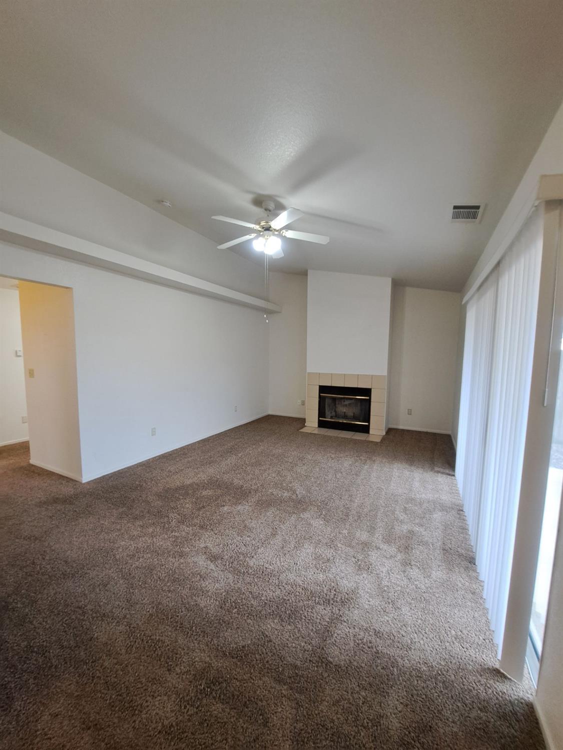 12486 Georgia Lane Madera, CA 93637 - Photo 4 of 17 a view of a livingroom with a ceiling fan and window