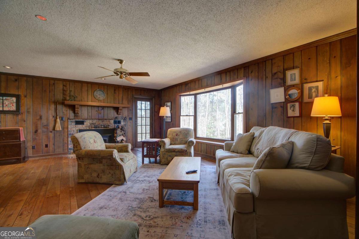 1043 Wilkerson Road Southwest Rome, GA 30165 - Photo 18 of 52 a living room with furniture two window and a fireplace