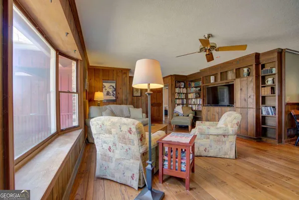 a view of a dining room with furniture window and wooden floor