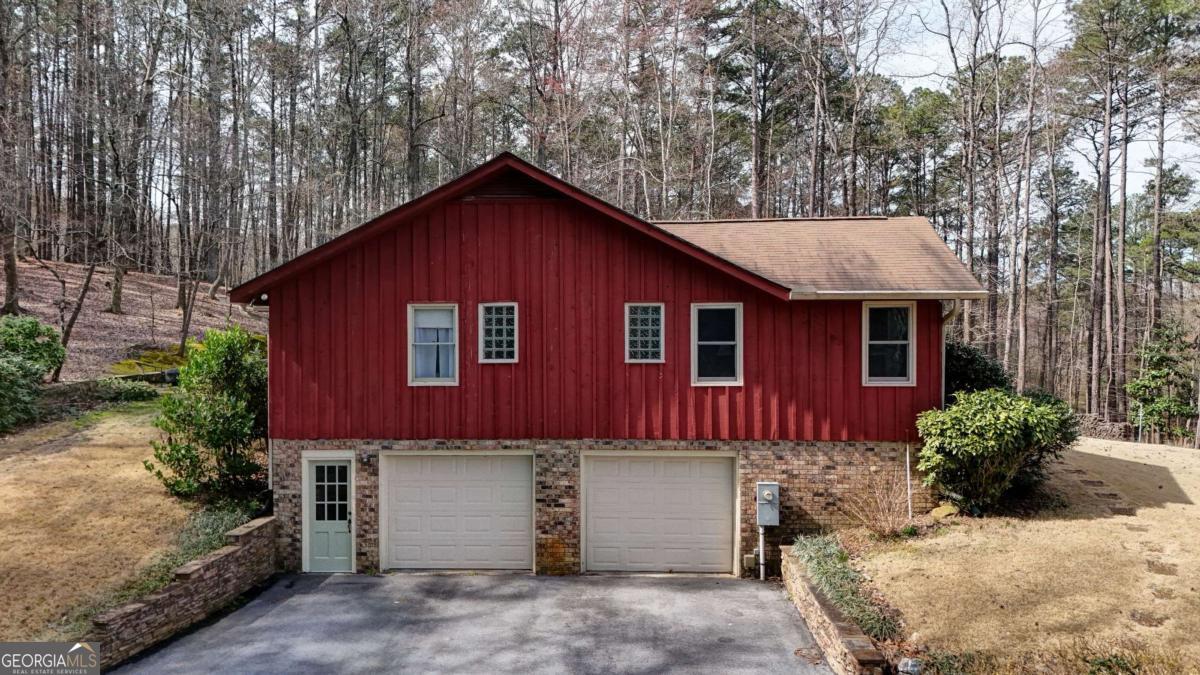1043 Wilkerson Road Southwest Rome, GA 30165 - Photo 2 of 52 a front view of a house with a yard