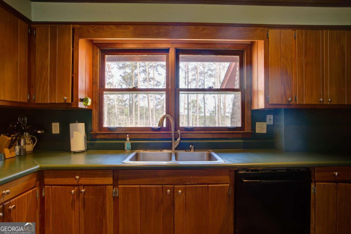 1043 Wilkerson Road Southwest Rome, GA 30165 - Photo 28 of 52 a kitchen with a sink a window and cabinets