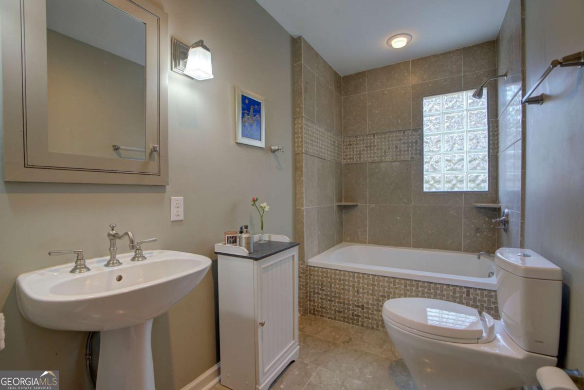 1043 Wilkerson Road Southwest Rome, GA 30165 - Photo 40 of 52 a bathroom with a sink a toilet and shower