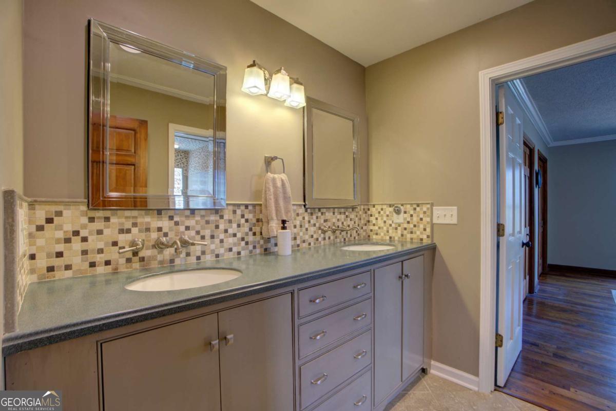 1043 Wilkerson Road Southwest Rome, GA 30165 - Photo 41 of 52 a bathroom with a sink and a mirror