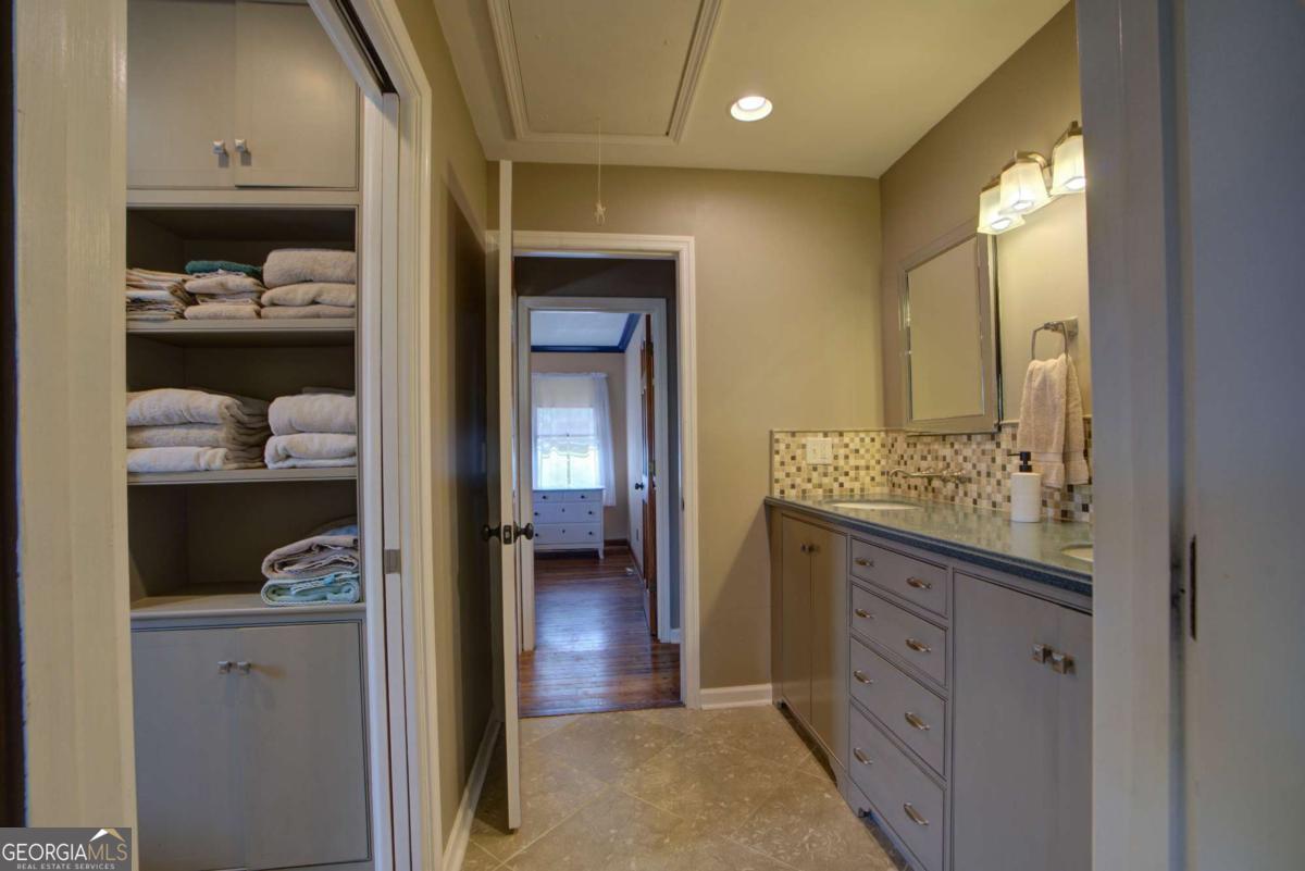 1043 Wilkerson Road Southwest Rome, GA 30165 - Photo 42 of 52 a bathroom with a granite countertop sink and a mirror