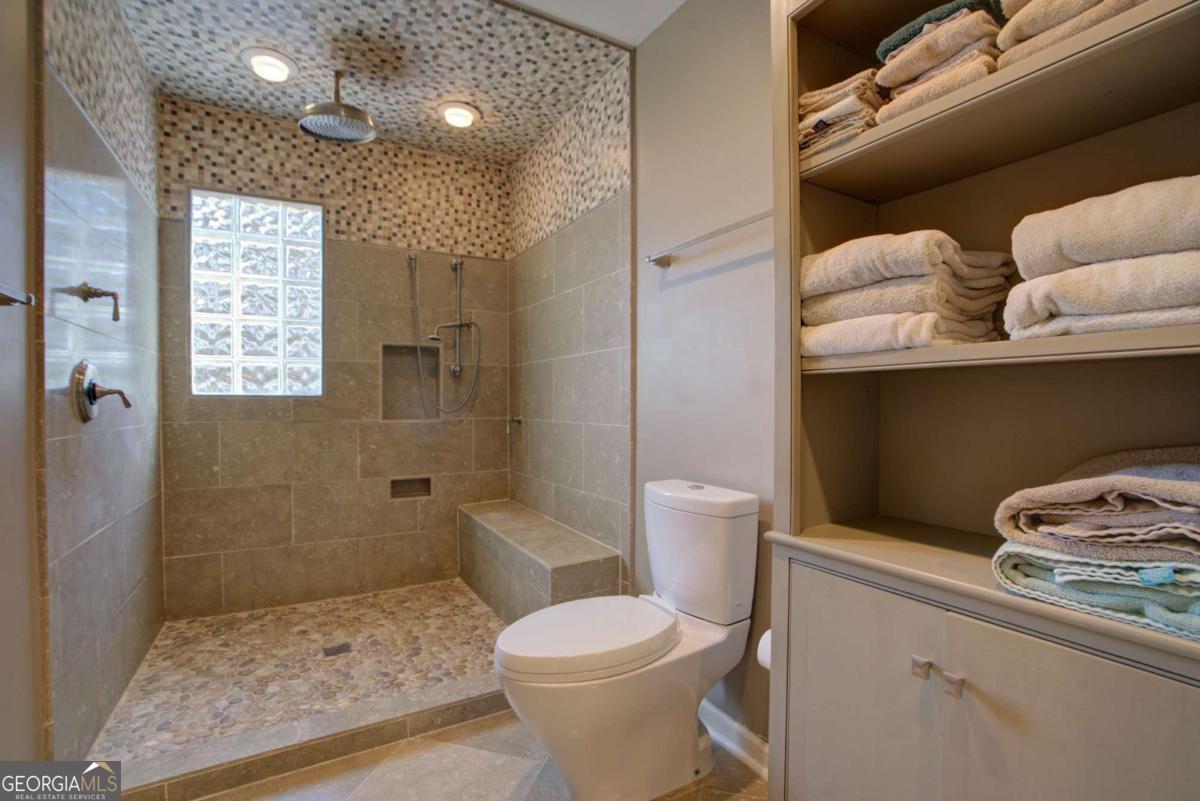 1043 Wilkerson Road Southwest Rome, GA 30165 - Photo 43 of 52 a bathroom with a toilet sink and shower