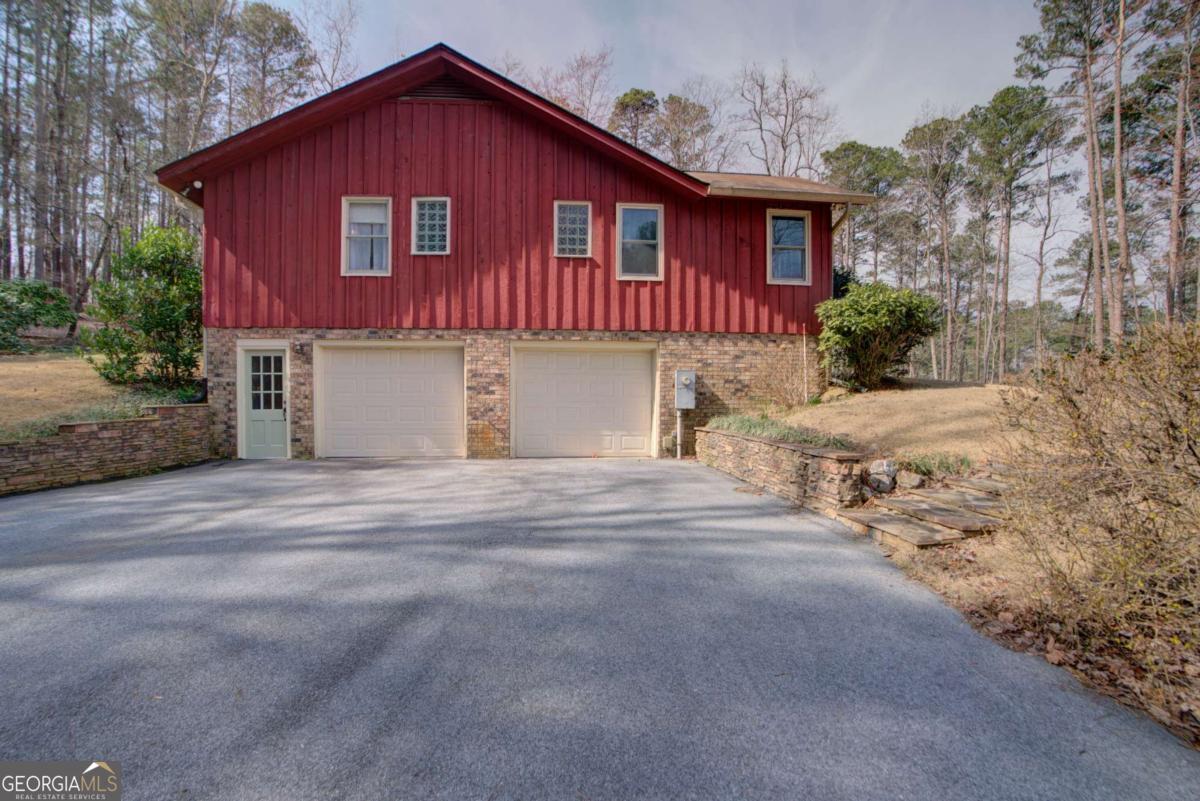 1043 Wilkerson Road Southwest Rome, GA 30165 - Photo 47 of 52 a front view of a house with a yard