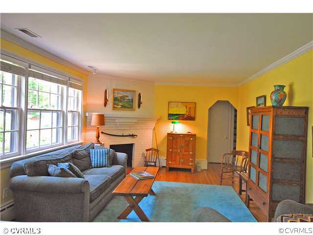 4237 Arrowhead Road Richmond, VA 23235 - Photo 3 of 14 a living room with couches a flat screen tv and a refrigerator