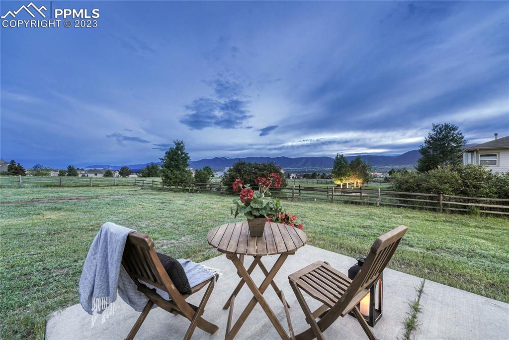 1185 Bowstring Road Monument, CO 80132 - Photo 15 of 46 a view of a chairs and table in patio with a yard