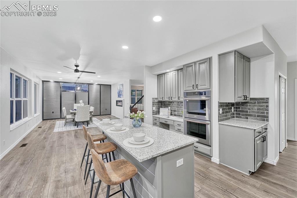 1185 Bowstring Road Monument, CO 80132 - Photo 16 of 46 a open kitchen with sink cabinets and wooden floor