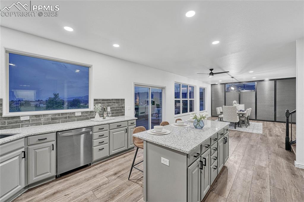 1185 Bowstring Road Monument, CO 80132 - Photo 17 of 46 a open kitchen with stainless steel appliances granite countertop a lot of counter space and wooden floors