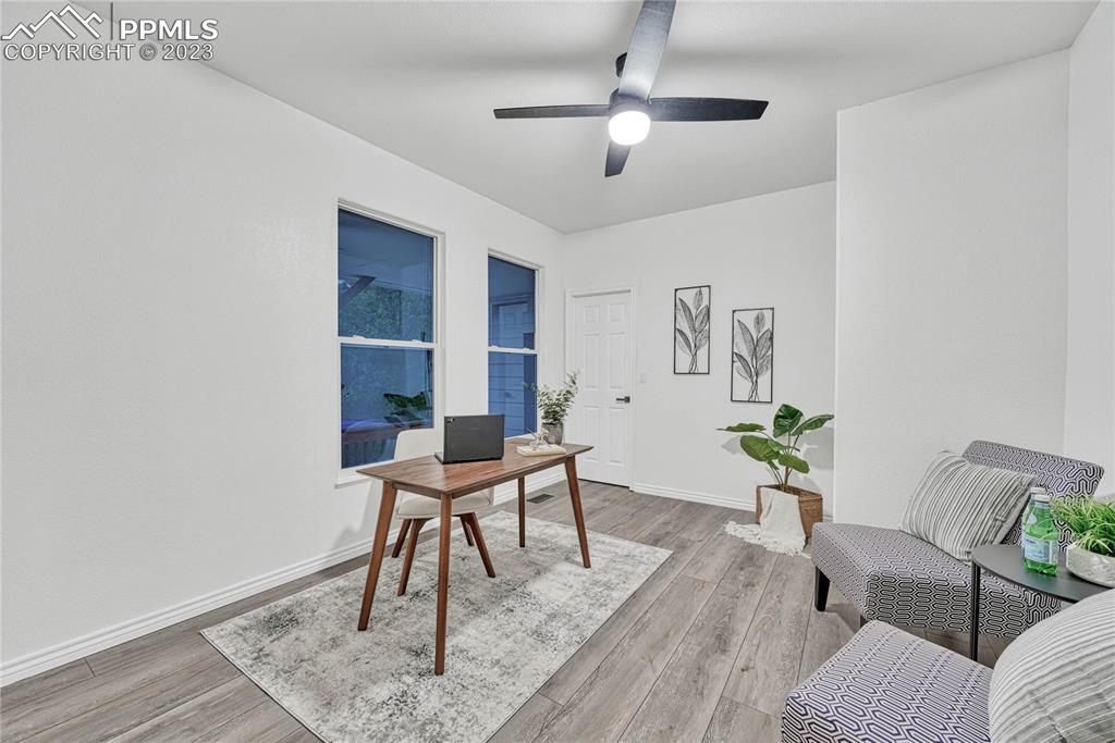 1185 Bowstring Road Monument, CO 80132 - Photo 18 of 46 a workspace with furniture and wooden floor