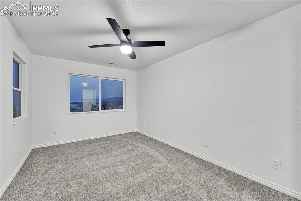 1185 Bowstring Road Monument, CO 80132 - Photo 29 of 46 an empty room with projector and windows