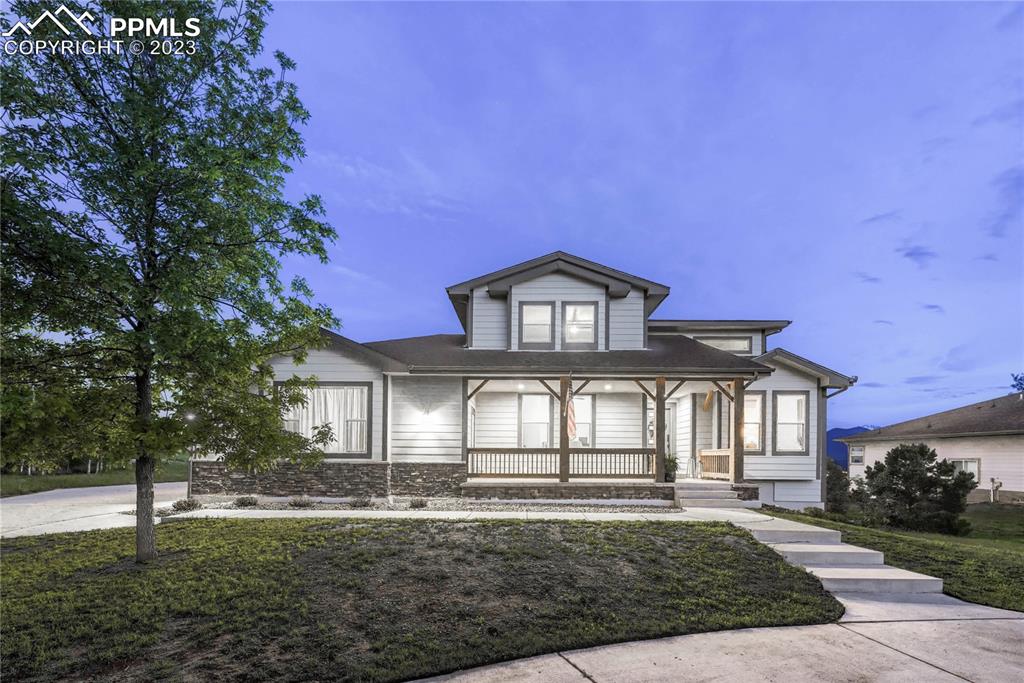 1185 Bowstring Road Monument, CO 80132 - Photo 3 of 46 a front view of a house with a yard