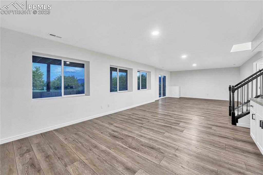 1185 Bowstring Road Monument, CO 80132 - Photo 32 of 46 a view of empty room with wooden floor and fan