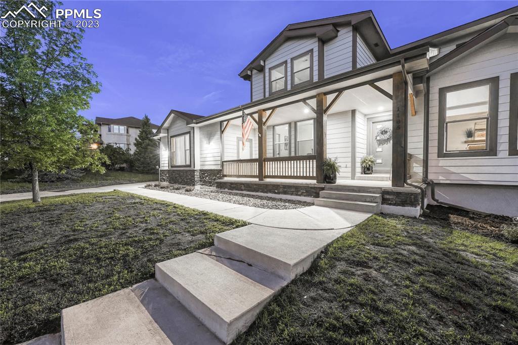 1185 Bowstring Road Monument, CO 80132 - Photo 4 of 46 a view of a house with a yard