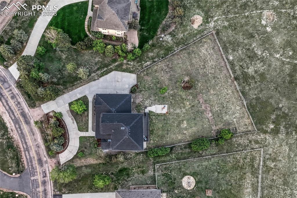 1185 Bowstring Road Monument, CO 80132 - Photo 43 of 46 an aerial view of a house with garden space and street view