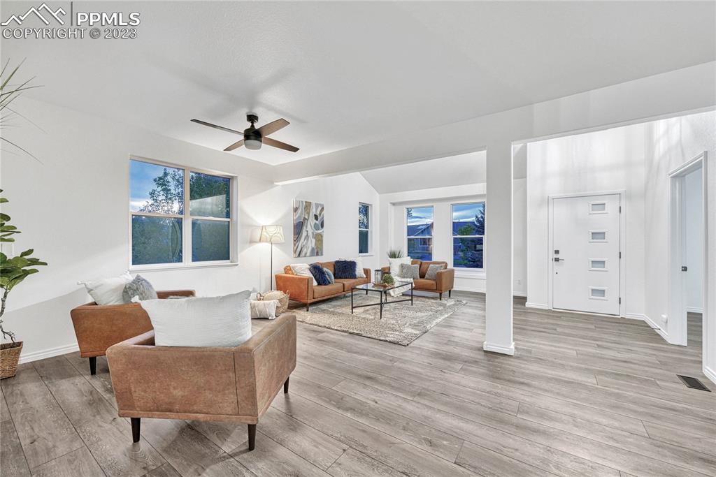 1185 Bowstring Road Monument, CO 80132 - Photo 6 of 46 a living room with furniture a dining table and a window