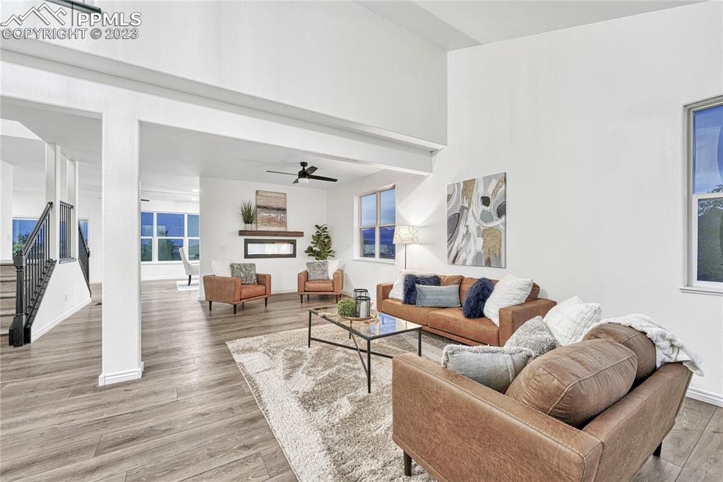 1185 Bowstring Road Monument, CO 80132 - Photo 7 of 46 a living room with furniture and wooden floor