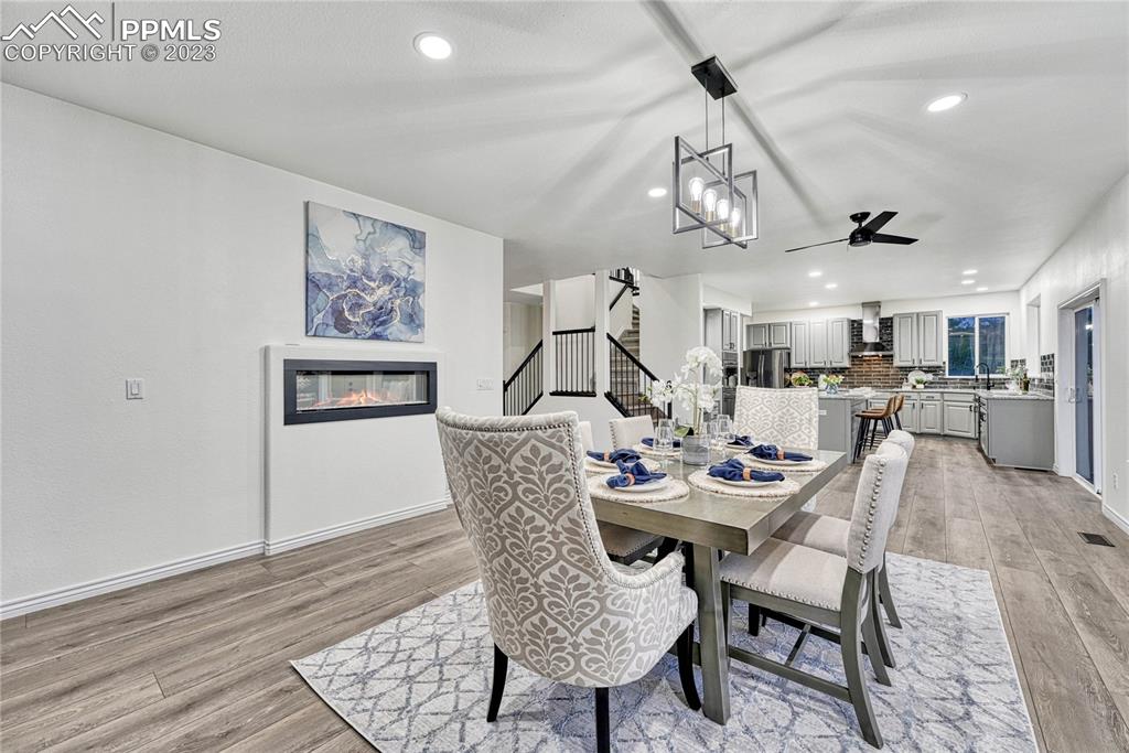 1185 Bowstring Road Monument, CO 80132 - Photo 9 of 46 a view of a dining room with furniture and wooden floor