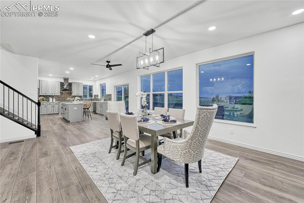 1185 Bowstring Road Monument, CO 80132 - Photo 10 of 46 a view of a dining room with furniture window and wooden floor