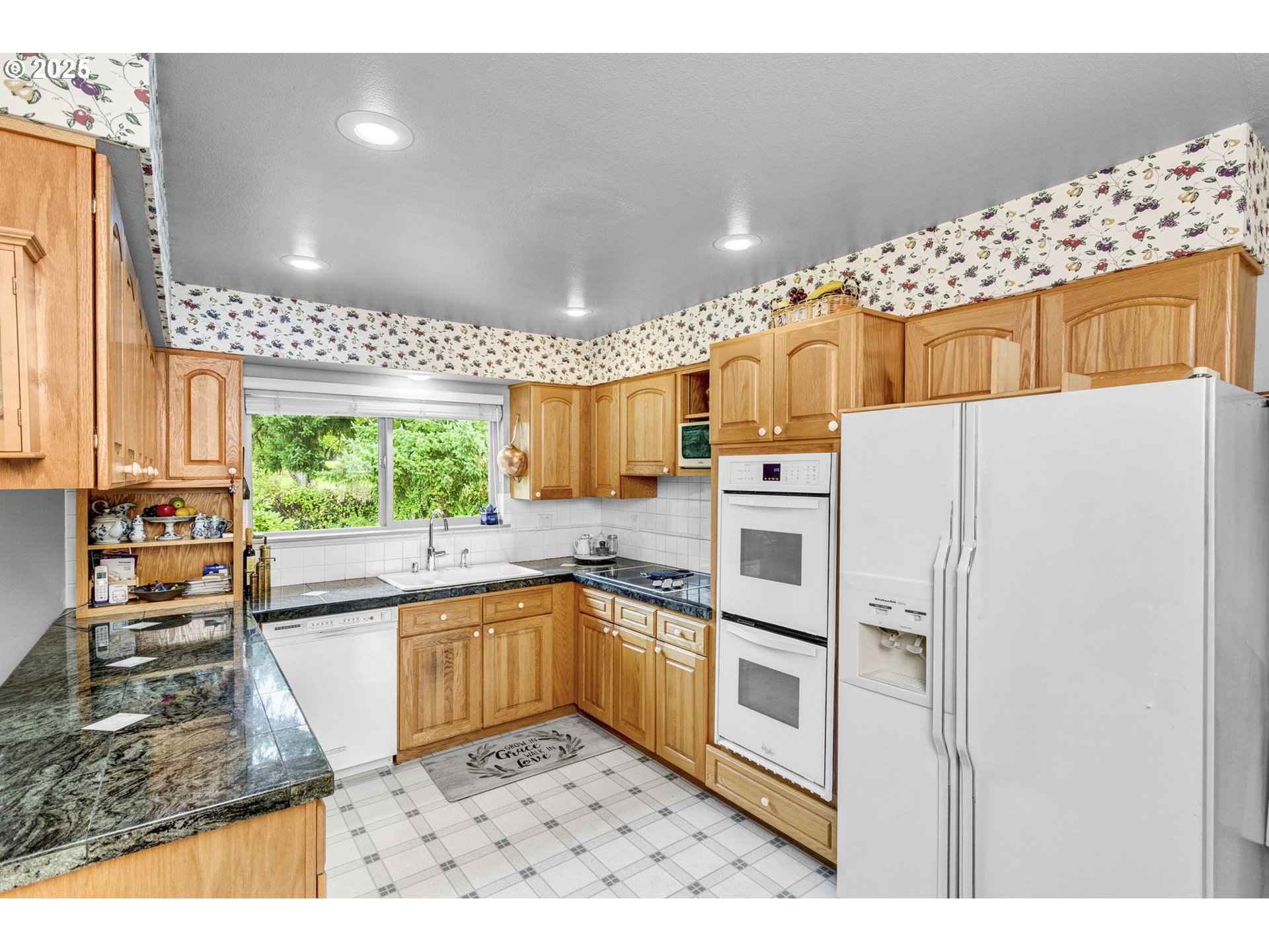 1114 Northeast 137th Avenue Portland, OR 97230 - Photo 14 of 45 a kitchen with granite countertop a refrigerator and microwave