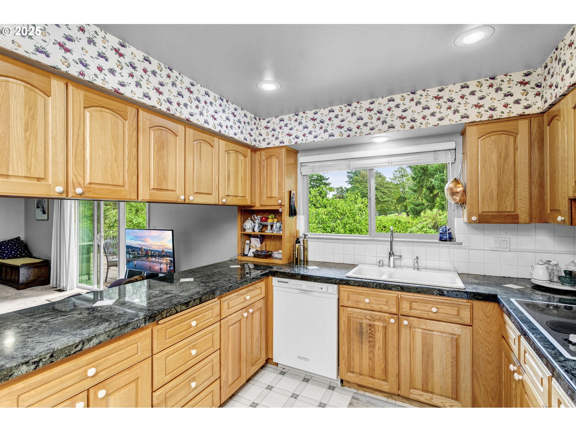 1114 Northeast 137th Avenue Portland, OR 97230 - Photo 15 of 45 a kitchen with granite countertop wooden cabinets a stove a sink and dishwasher next to a window