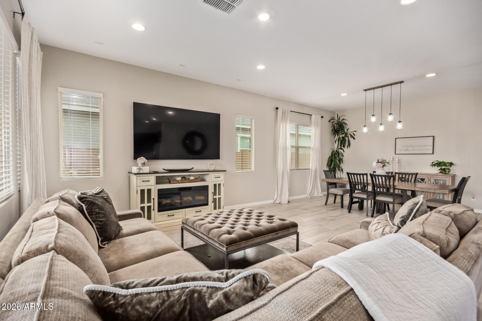 3918 West McNeil Street Laveen, AZ 85339 - Photo 11 of 42 a living room with furniture and a flat screen tv