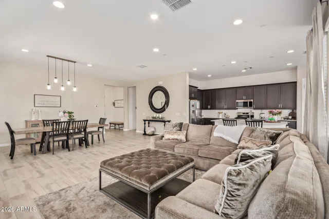 a living room with lots of furniture and kitchen view