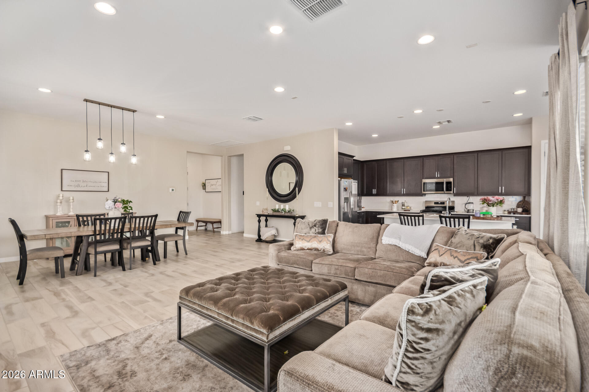 3918 West McNeil Street Laveen, AZ 85339 - Photo 12 of 42 a living room with lots of furniture and kitchen view