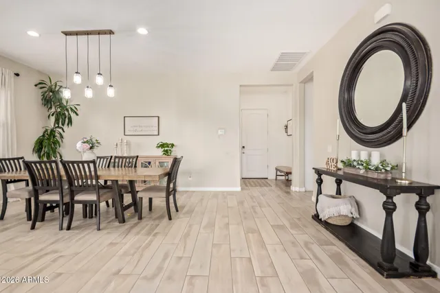 a view of a dining room with furniture and chandelier