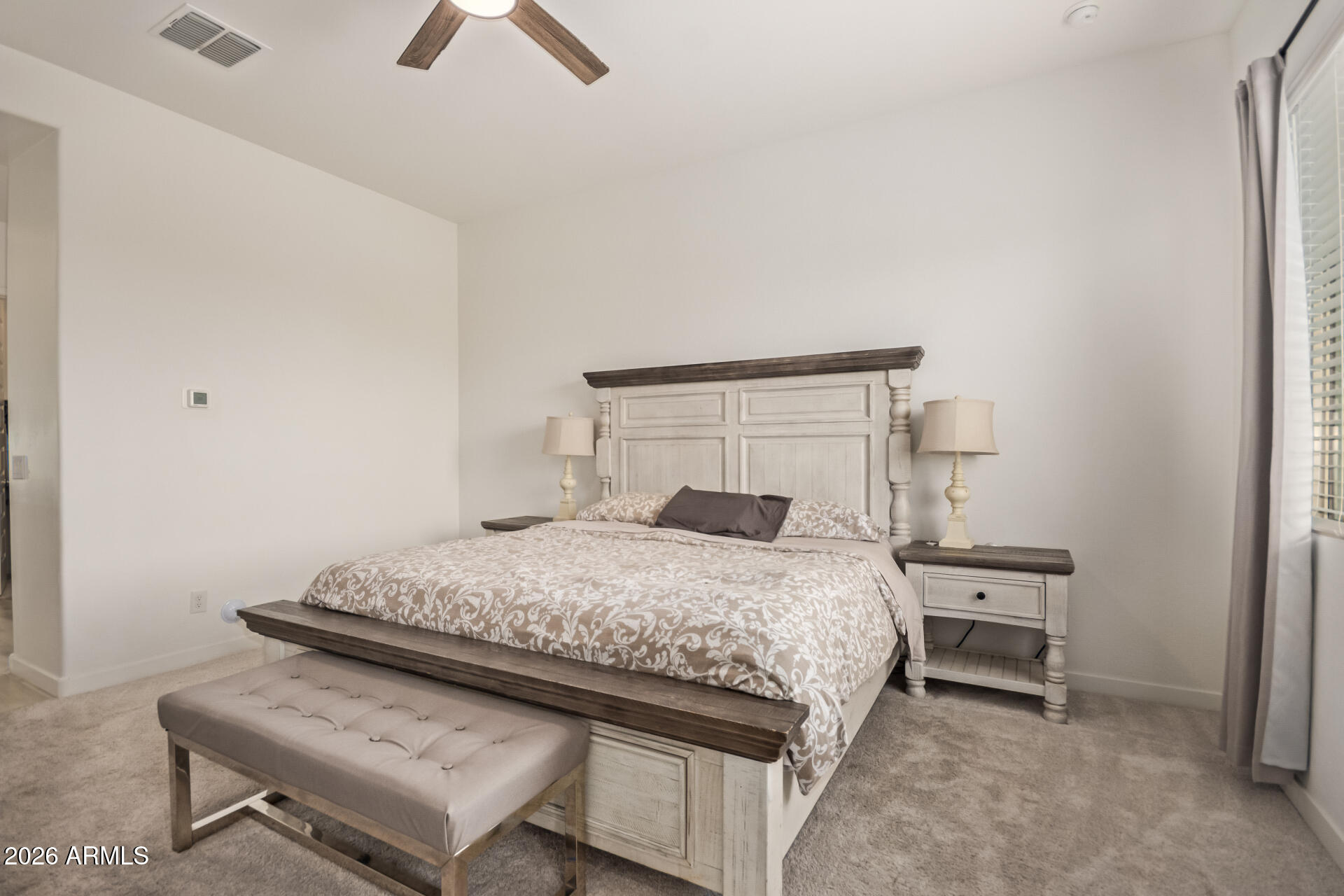 3918 West McNeil Street Laveen, AZ 85339 - Photo 20 of 42 a bedroom with a bed and a chandelier