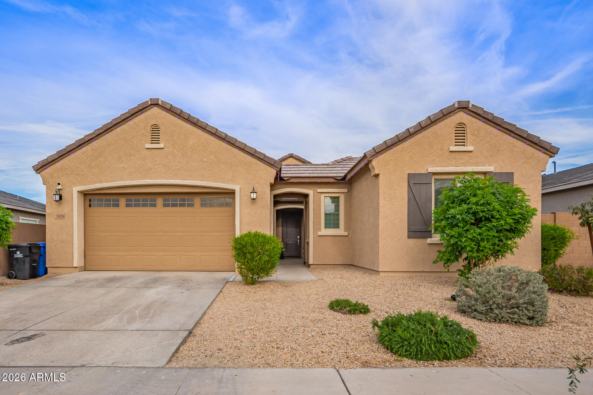 3918 West McNeil Street Laveen, AZ 85339 - Photo 2 of 42 a front view of a house with a yard and garage