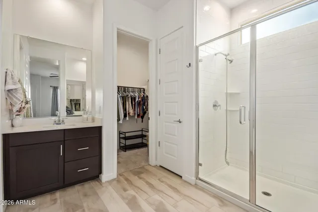 a bathroom with a shower sink and mirror