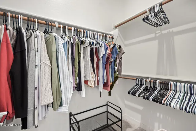 a view of walk in closet with clothes