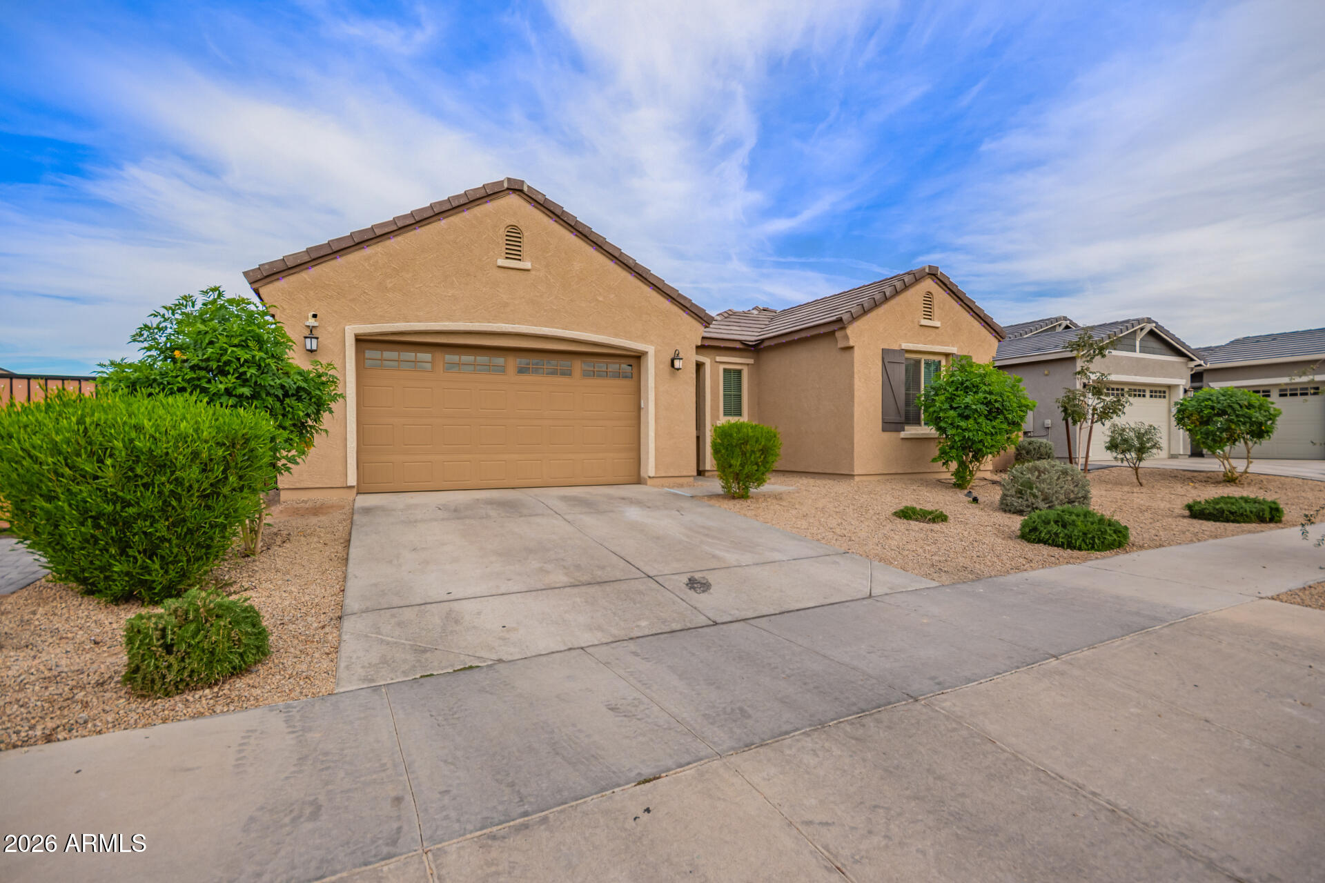 3918 West McNeil Street Laveen, AZ 85339 - Photo 3 of 42 a front view of a house with a yard and garage