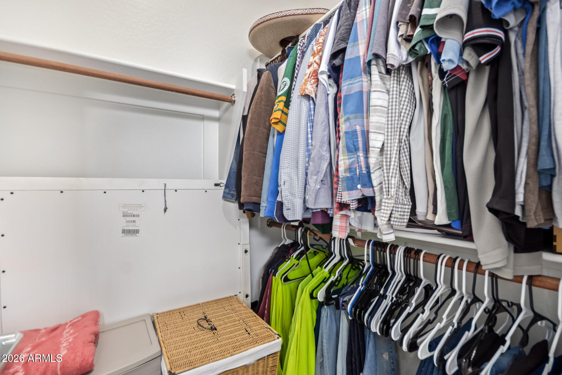 3918 West McNeil Street Laveen, AZ 85339 - Photo 33 of 42 a view of walk in closet with clothes and shoes