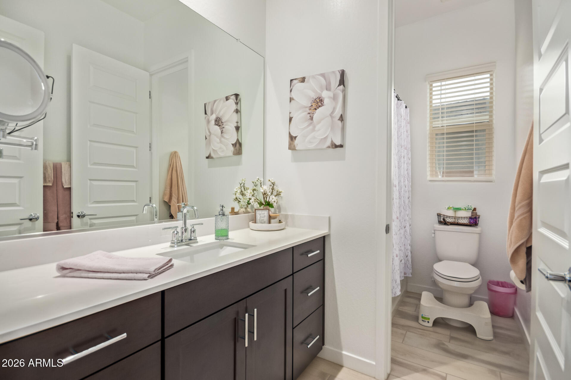 3918 West McNeil Street Laveen, AZ 85339 - Photo 34 of 42 a bathroom with a granite countertop toilet sink and mirror