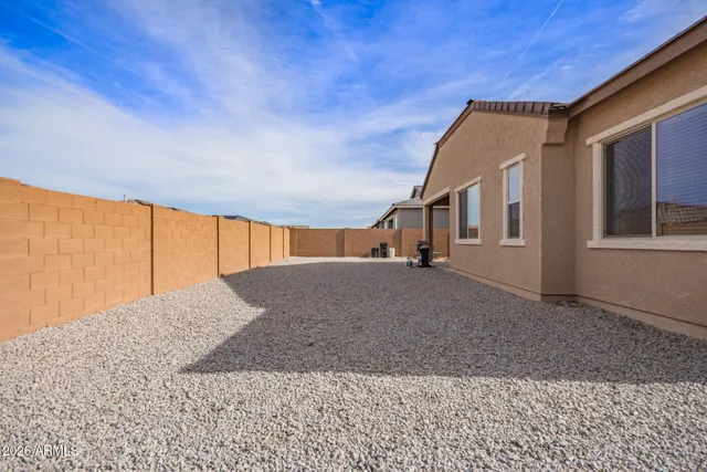 a view of a house with a backyard