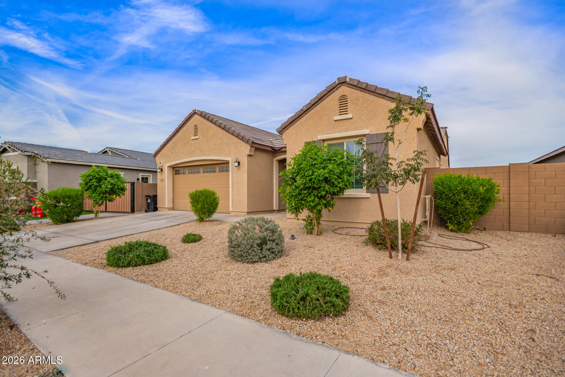 3918 West McNeil Street Laveen, AZ 85339 - Photo 5 of 42 a front view of a house with garden