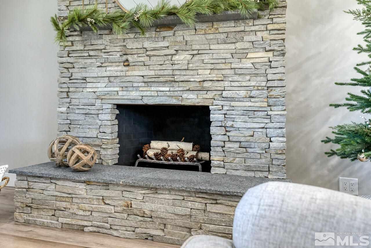 1025 Foothill Road Reno, NV 89511 - Photo 8 of 40 a room with a fireplace and potted plants