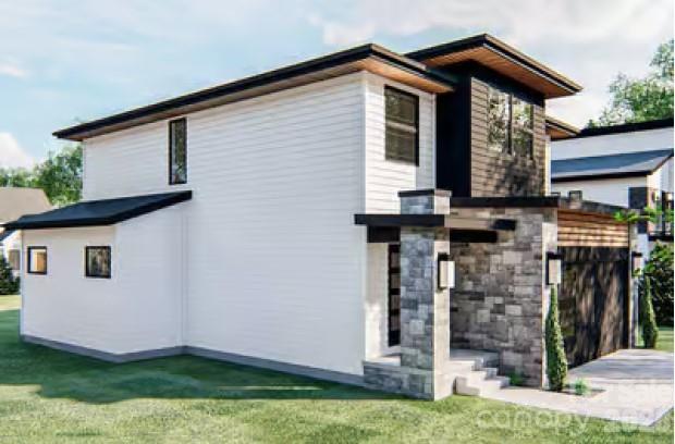 313 Iron Ridge Loop, Unit 16 Asheville, NC 28806 - Photo 3 of 9 a front view of a house with garden