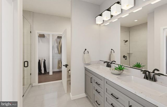 a bedroom with a bed painting on wall and a large window