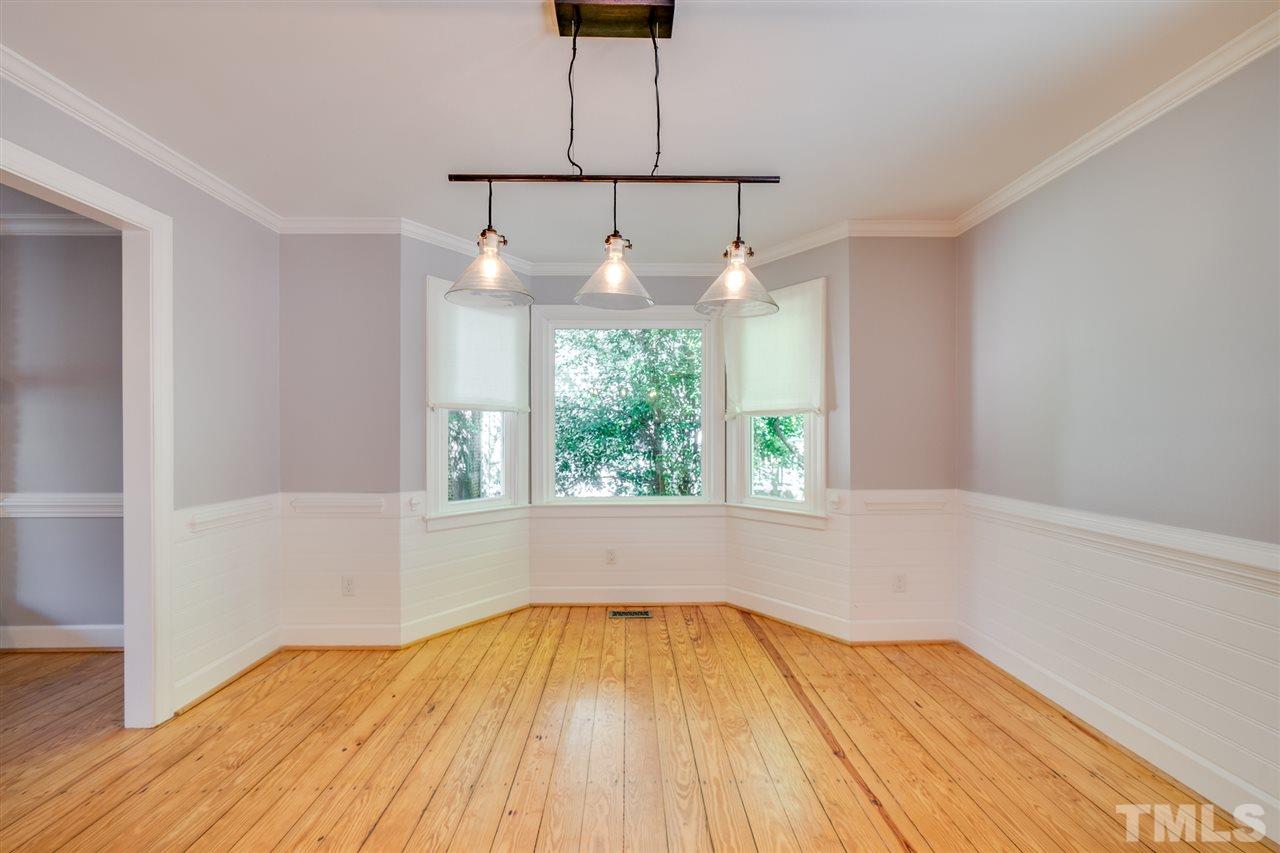 2116 Quail Ridge Road Raleigh, NC 27609 - Photo 11 of 30 a view of empty room with wooden floor and fan