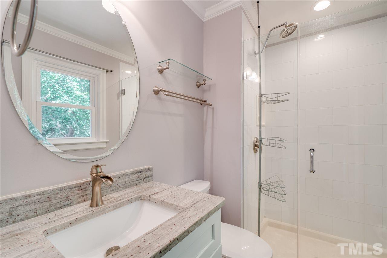 2116 Quail Ridge Road Raleigh, NC 27609 - Photo 14 of 30 a bathroom with a granite countertop sink a toilet and shower