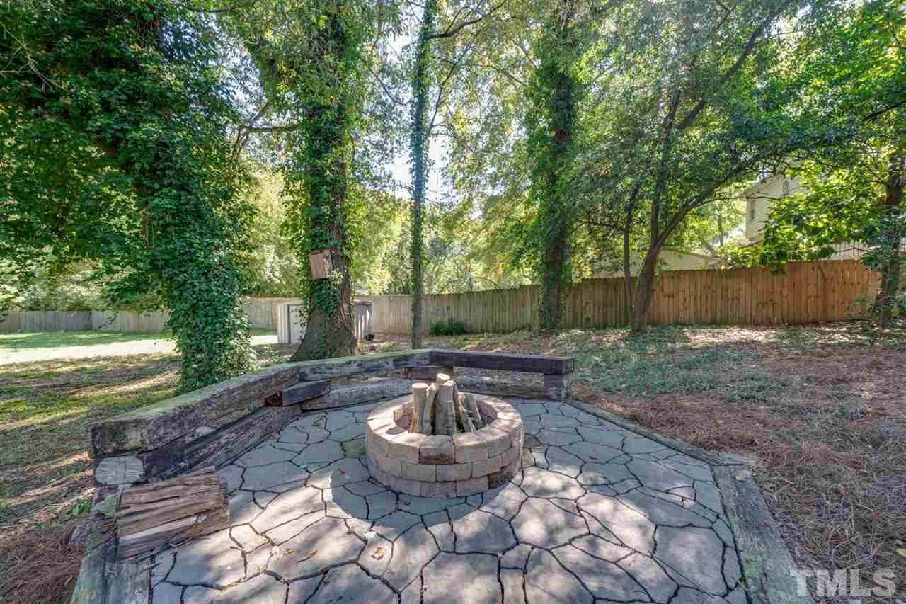 2116 Quail Ridge Road Raleigh, NC 27609 - Photo 24 of 30 a backyard of a house with fountain table and chairs